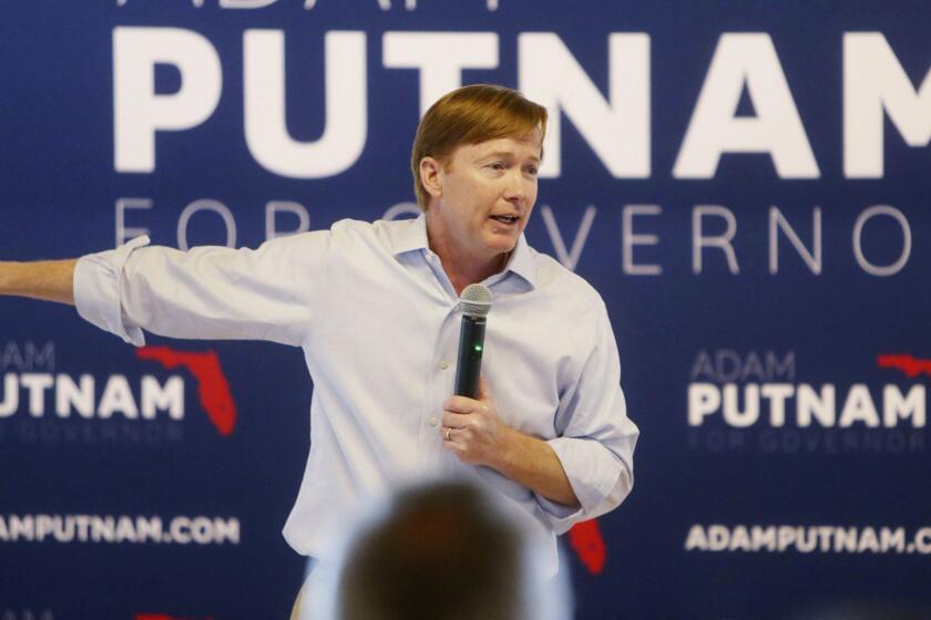 In a Tuesday, Aug. 21, 2018 photo, at the start of his bus tour, Agriculture Commissioner Adam Putnam, a gubernatorial candidate, makes a campaign stop to give a speech during a "Polk for Putnam" rally held at the Magnolia Building in Lakeland, Fla. (Octavio Jones/The Tampa Bay Times via AP)