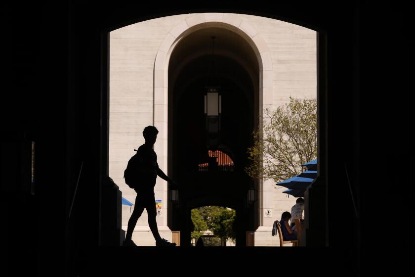 CLAREMONT, CA - APRIL 10, 2024 - A student makes their way through a plaza on the Pomona College campus where there has been intense activism and police arrests over Israel-Palestine activism in Claremont on April 10, 2024. (Genaro Molina/Los Angeles Times)