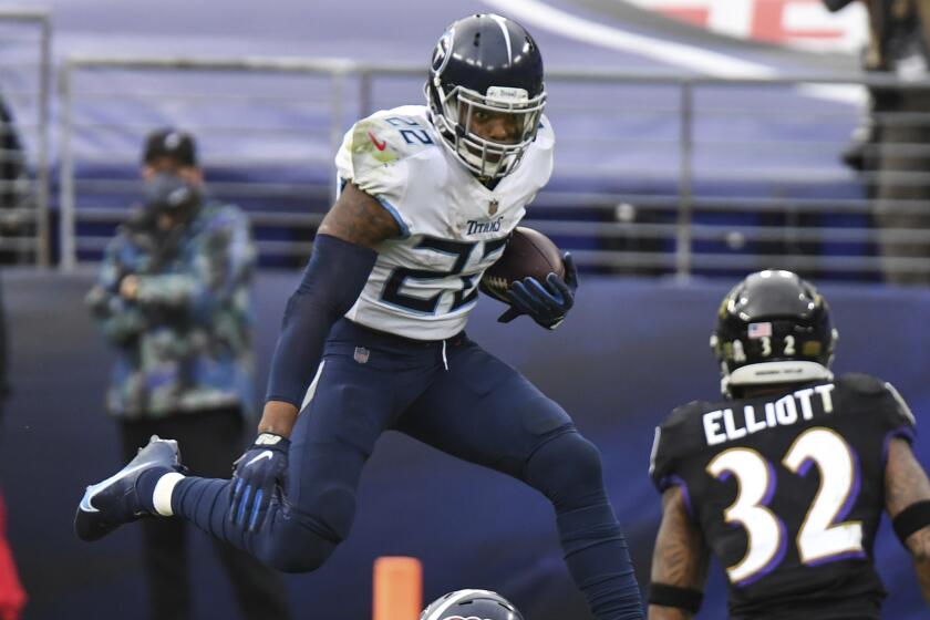 Tennessee Titans running back Derrick Henry (22) hurdles defender during the second half.