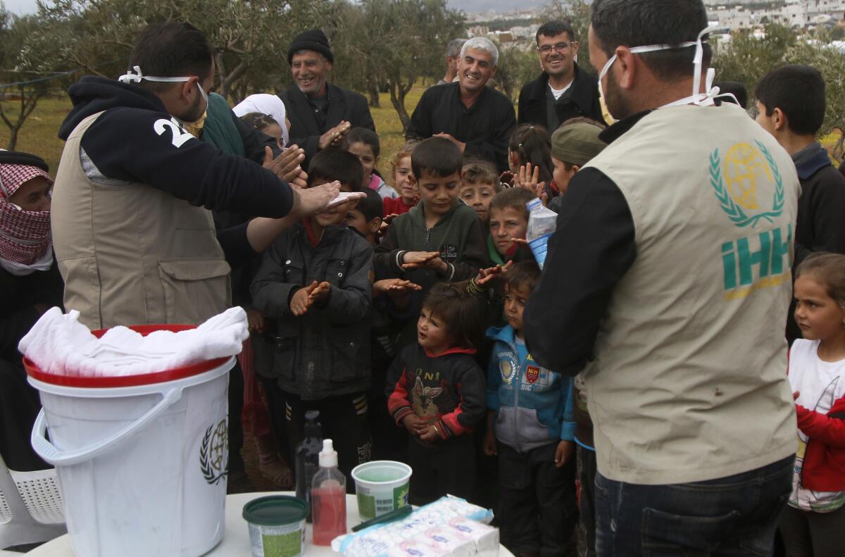 Turkish aid workers with children at a refugee camp in northern Syria.