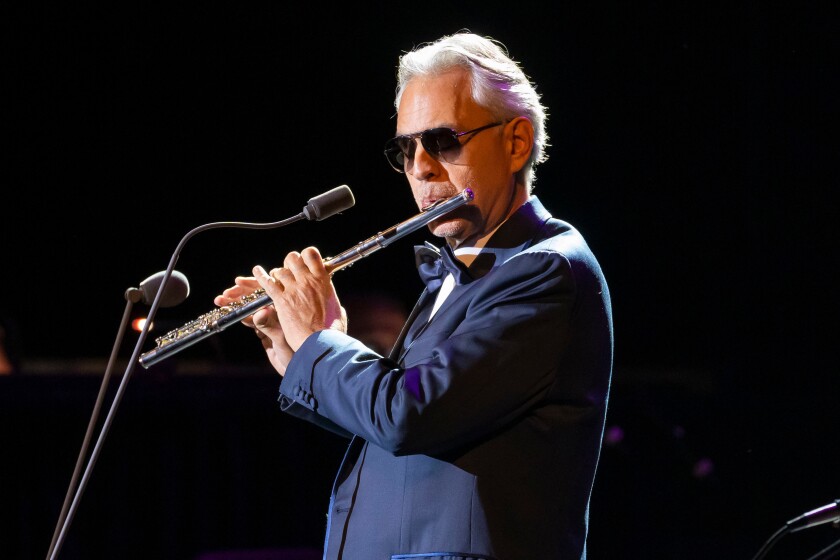 Andrea Bocelli playing the flute entertains the Segerstrom Center for the Arts Candlelight Concert crowd.