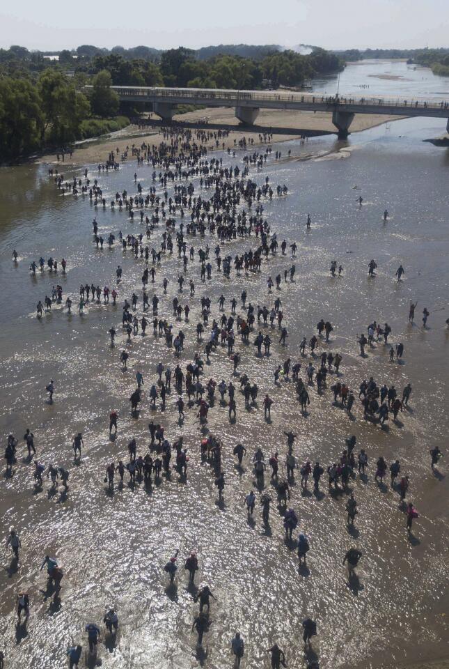 Central American migrants cross the Suchiate River by foot from Tucun Uman, Guatemala, top left, to Ciudad Hidalgo, Mexico.