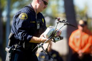 Alameda County Sheriff's Deputy Dave Durbin carries a drone while demonstrating a search and rescue operation, Friday, Aug. 14, 2015, in Dublin, Calif. As law enforcement joins the ranks of hobbyists sending drones into California skies, civil liberties advocates are raising the specter of unchecked police surveillance and state lawmakers are drafting limits. (AP Photo/Noah Berger)