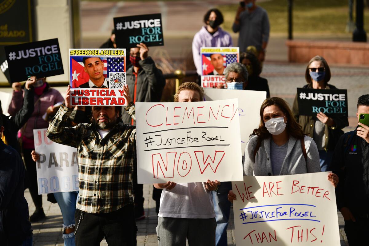 People hold signs in support of truck driver Rogel Aguilera-Mederos