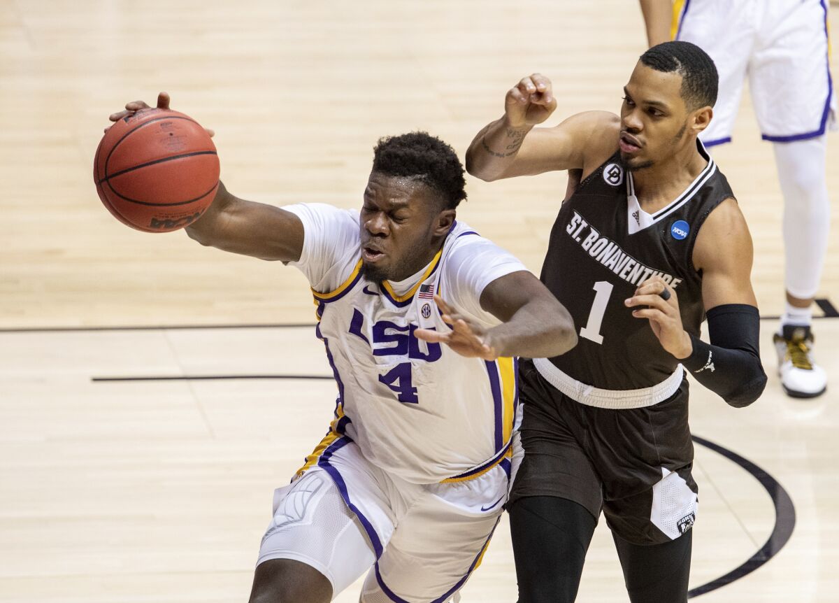 LSU forward Darius Days chases after a loose ball with St. Bonaventure guard Dominick Welch.