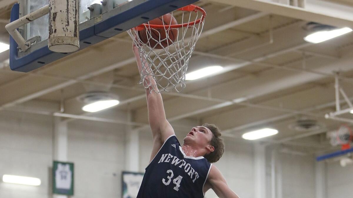 Newport Harbor High's Dayne Chalmers dunks the ball during the first half against Pacifica at the Century Elks Holiday Classic in Santa Ana on Dec. 30, 2017. He finished with 18 points.