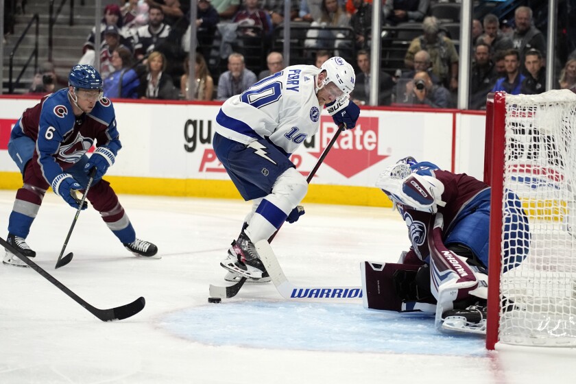 Lightning forward Corey Perry tries to shoot the puck in front of Avalanche goaltender Darcy Kuemper.
