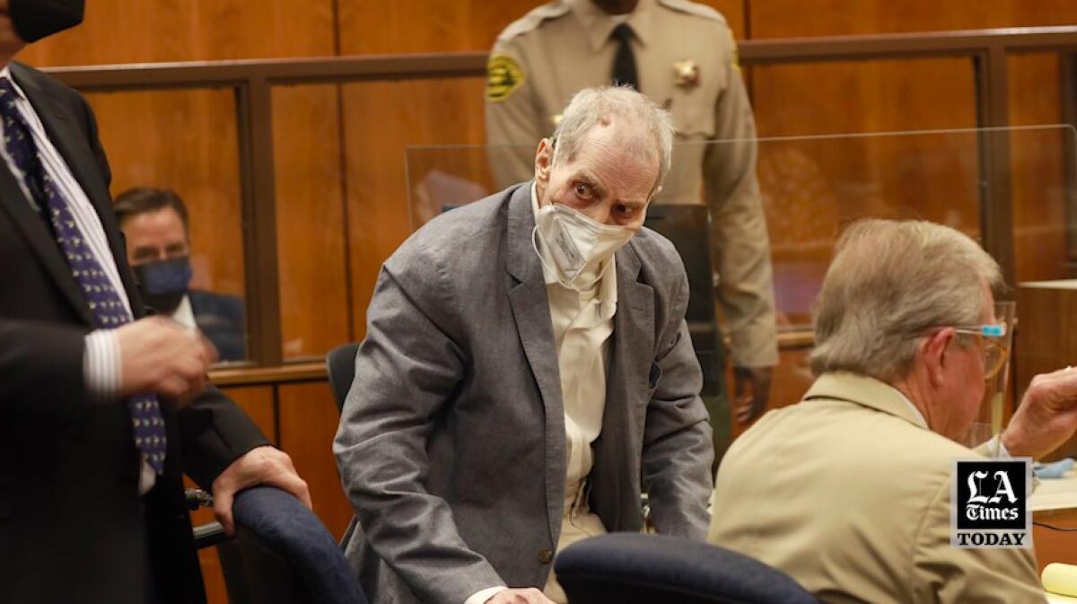 Robert Durst looks out at the gallery while wearing a mask
