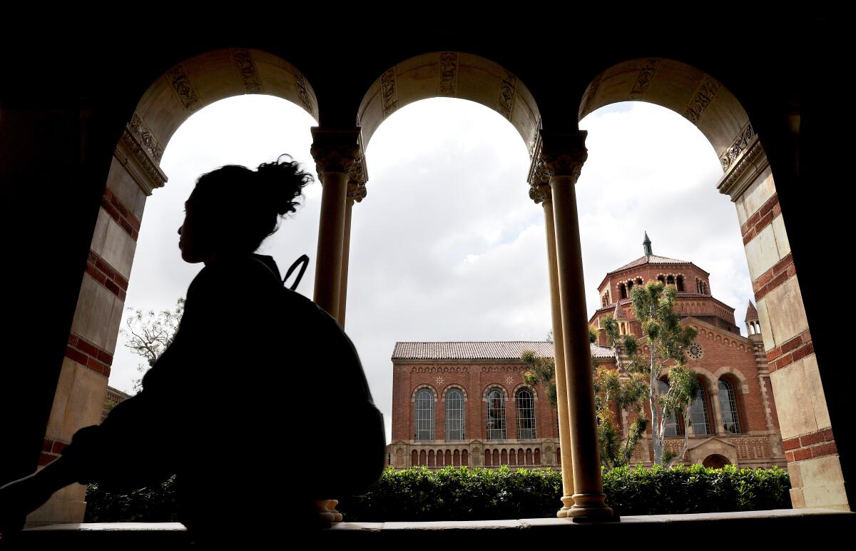 A student walks through a passageway on UCLA campus.