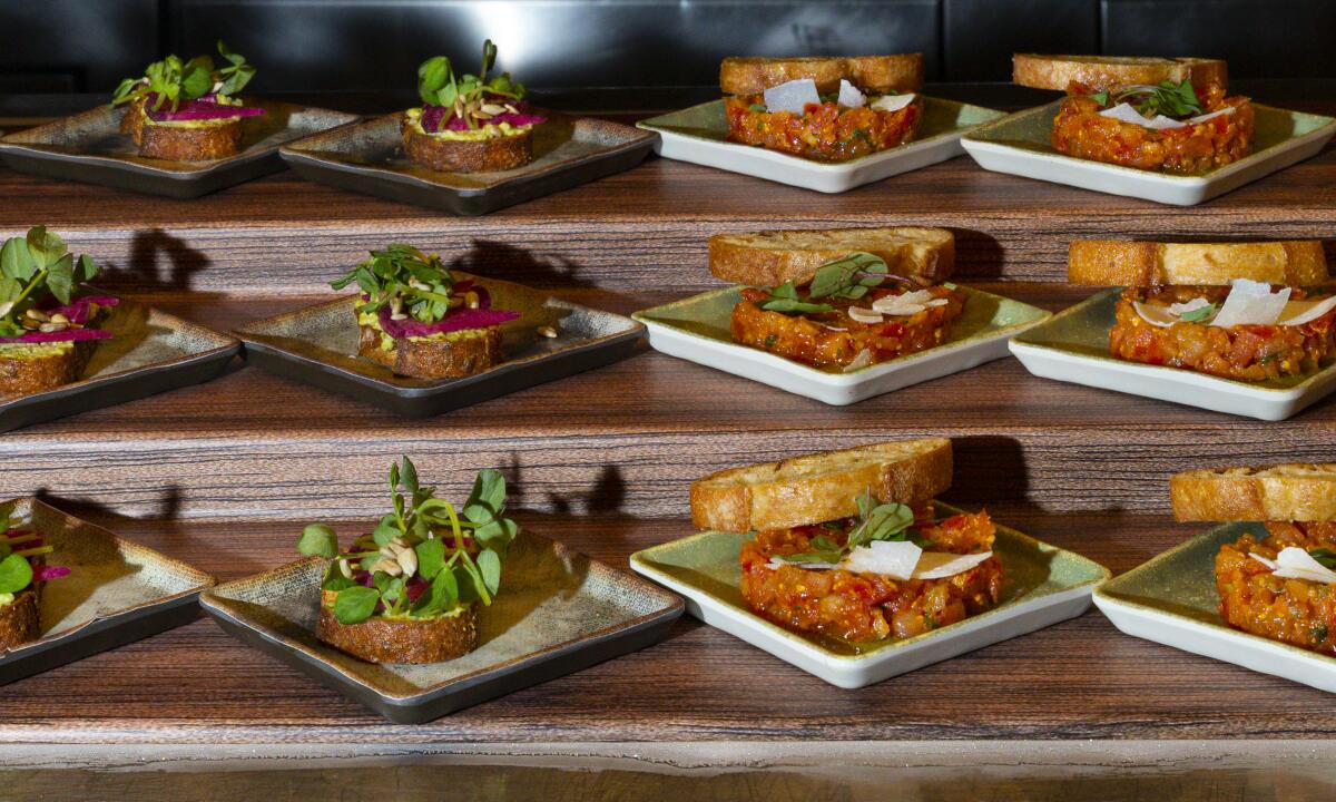 Pea toast, left, and tomato and basil tartar dishes at the Bacchanal Buffet at Caesars Palace.