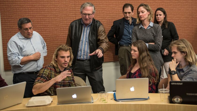 Steven Weinstein, center, an instructor of a class called Hacking 4 Diplomacy at Stanford University, helps students from a variety of fields come up with strategies to solve real-world problems.