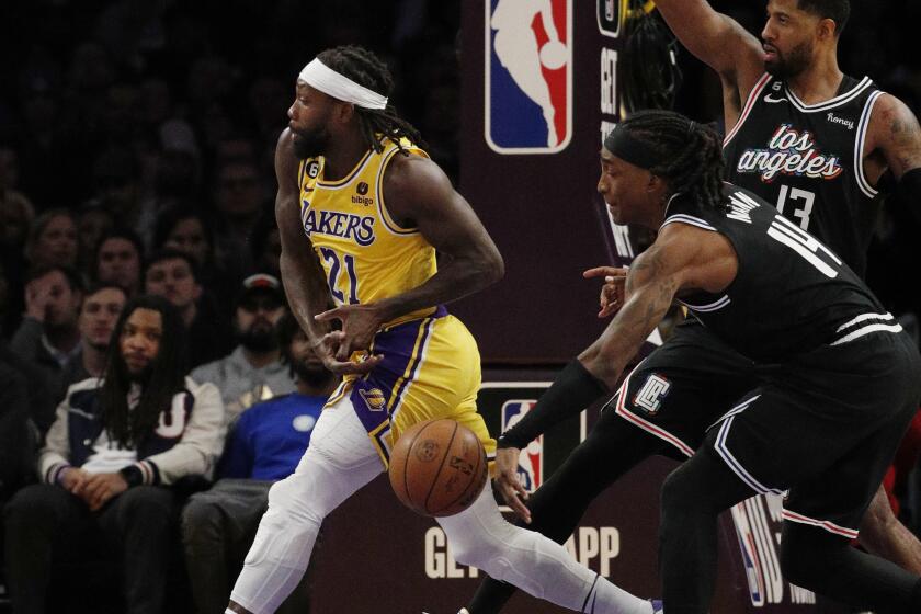 Clippers guard Terance Mann (14) strips the ball from Los Angeles Lakers guard Patrick Beverley