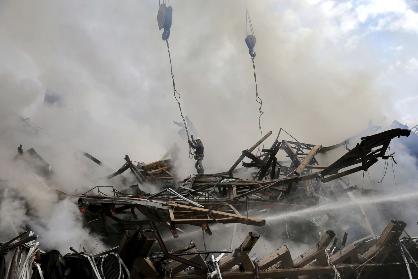 Burning Tehran high-rise collapses