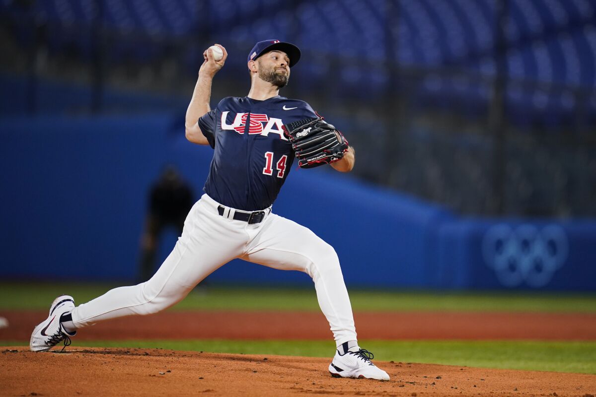 FILE - United States' Nick Martinez pitches during the first inning of the gold medal baseball game against Japan at the 2020 Summer Olympics, Saturday, Aug. 7, 2021, in Yokohama, Japan. Martinez signed a one-year contract with the San Diego Padres on Wednesday, March 16, finalizing a deal that was delayed by the Major League Baseball lockout. (AP Photo/Sue Ogrocki, File)
