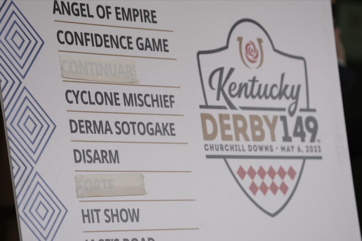 A poster shows Continuar and derby favorite Forte scratched from the lineup for the Kentucky Derby 