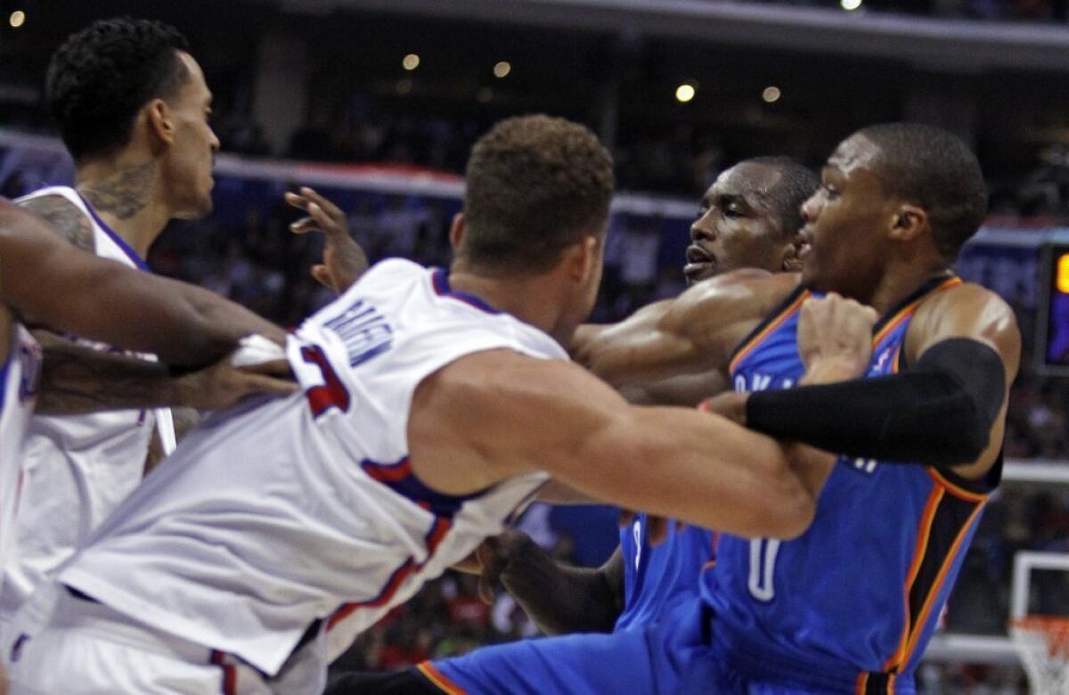 Matt Barnes, left and Blake Griffin, second from left, tangle with Oklahoma City Thunder forward Serge Ibaka, second from right and Thunder guard Russell Westbrook