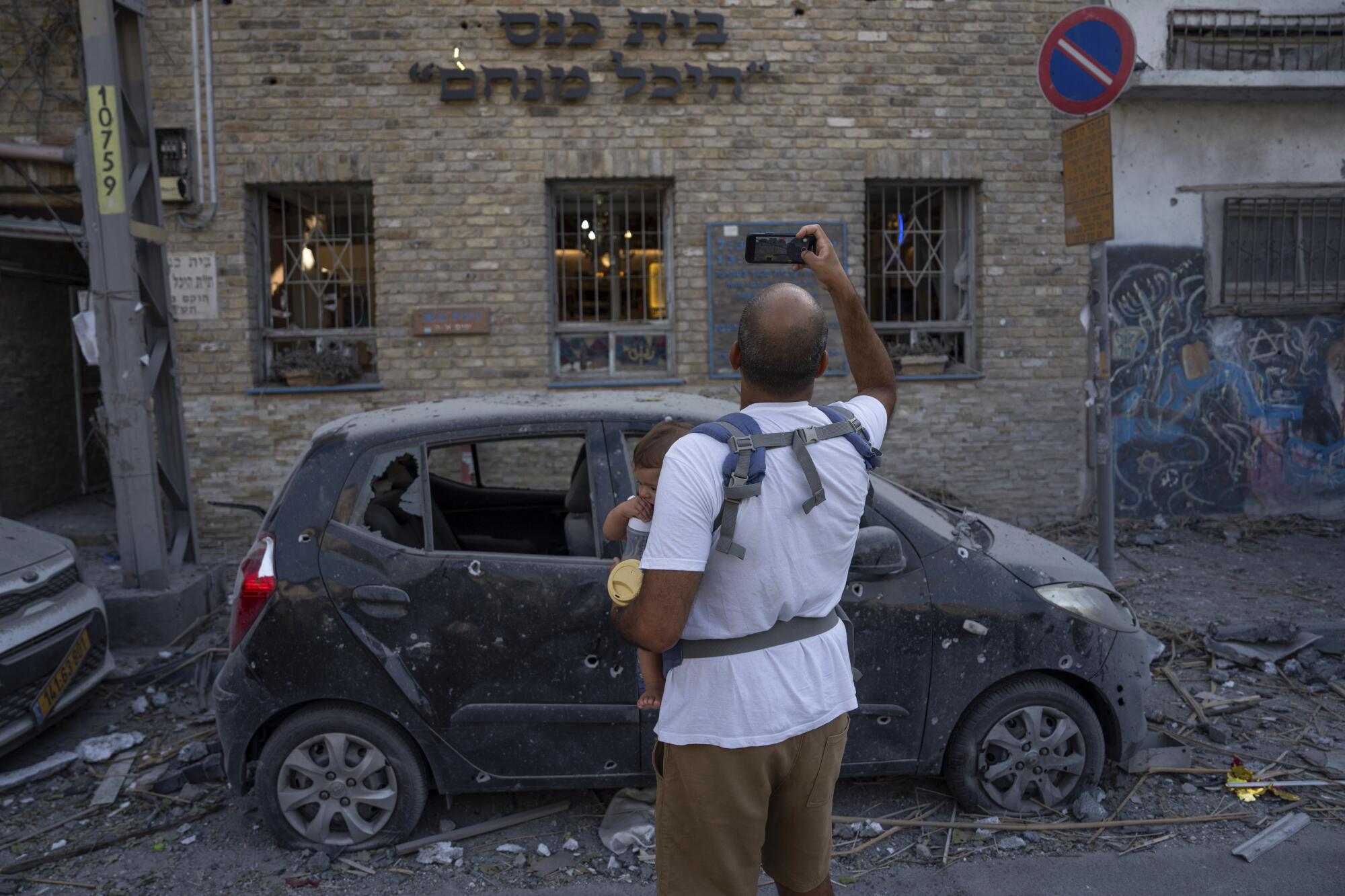 Man taking photo of a ruined building in Tel Aviv