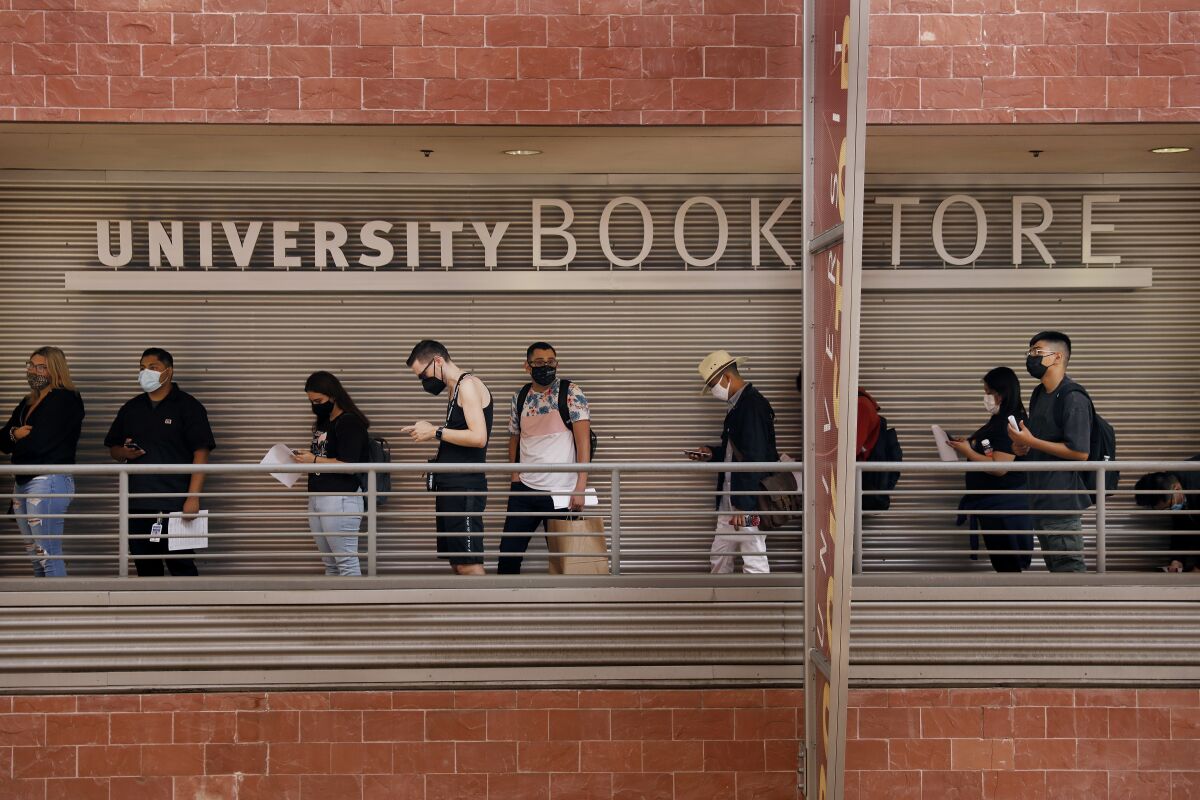 Students wait in line at a university bookstore. 