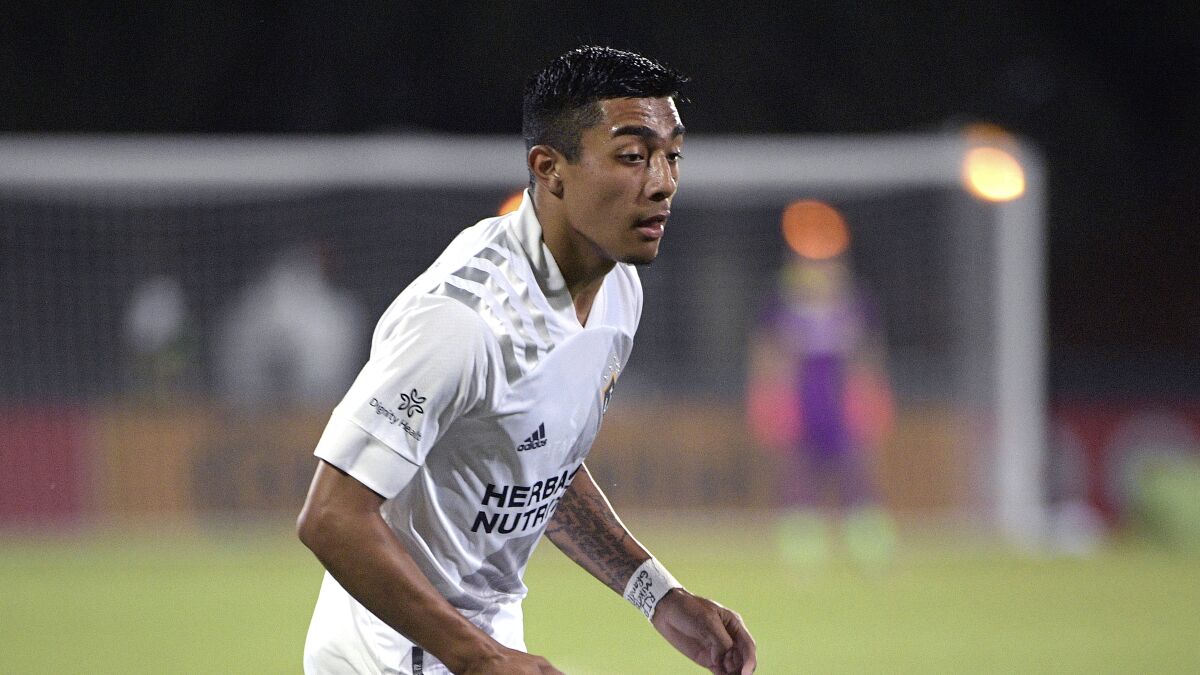 Galaxy defender Julian Araujo chases after the ball.