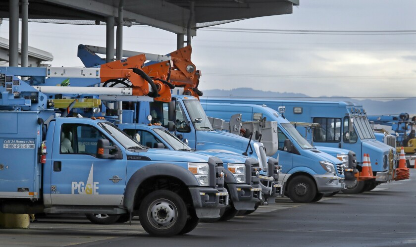 A line of blue Pacific Gas & Electric trucks