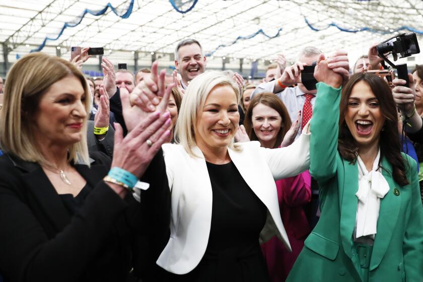 Sinn Fein's Vice President Michelle O'Neill, centre, celebrates with party colleagues after being elected in Mid Ulster at the Medow Bank election count centre in Magherafelt , Northern Ireland, Friday, May, 6, 2022. (AP Photo/Peter Morrison)