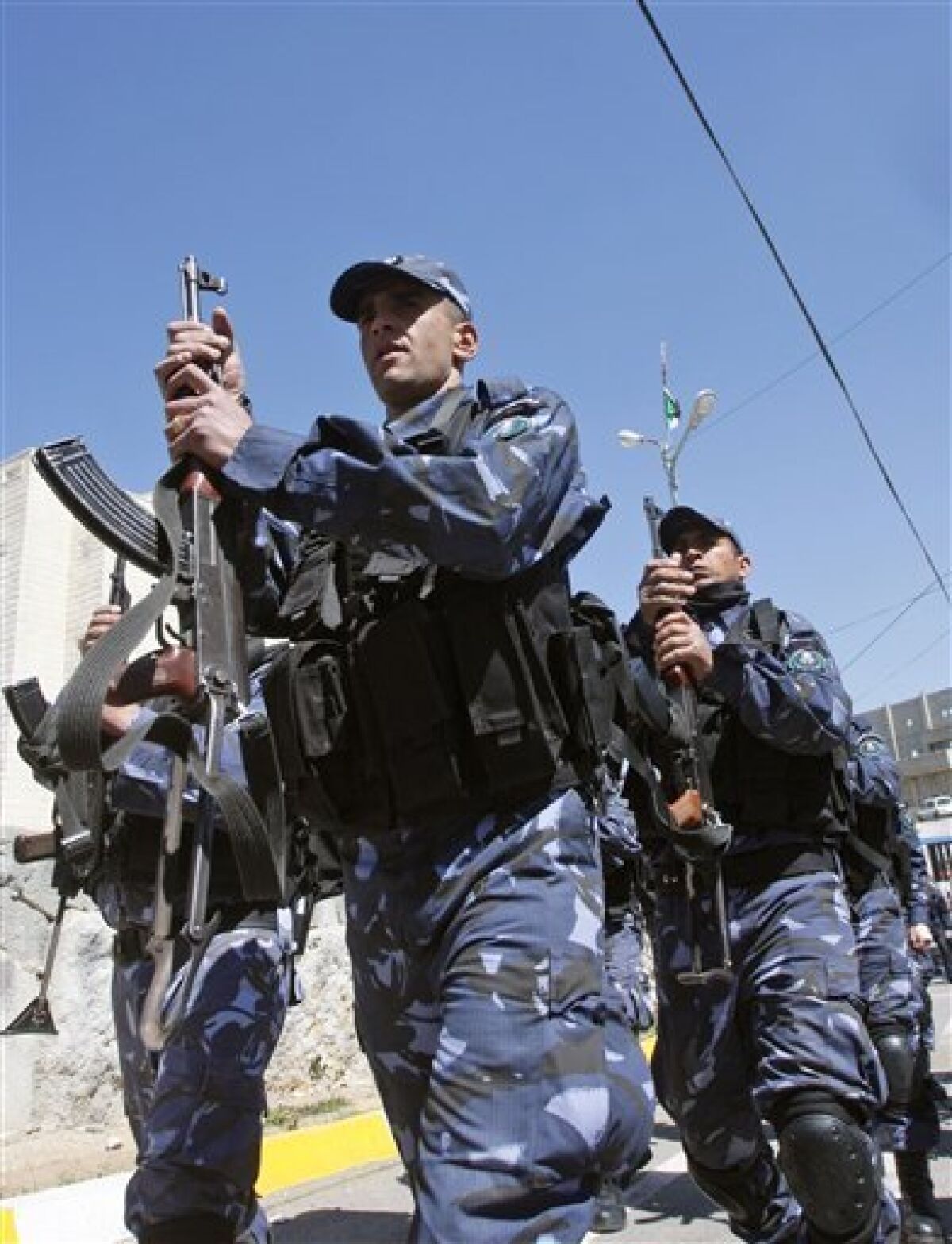 In this photo taken on March 17, 2009, Palestinian police officers march during a training session in the West Bank city of Hebron. Palestinian law enforcement authorities are facing a unique dilemma: how to maintain security when criminals have more freedom of movement than police do. Police say they can't arrest the crooks because they live in an Israeli-controlled area, which Palestinian forces can't enter freely. Palestinian police can only enter Israeli-controlled areas of the West Bank with permission, which they say is often difficult or impossible to obtain, making these areas ideal hideouts for criminals.(AP Photo/Nasser Shiyoukhi)