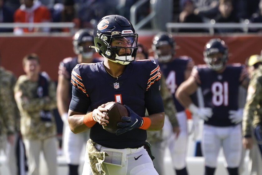 Chicago Bears quarterback Justin Fields drops back to pass during the first half of an NFL football game against the Baltimore Ravens Sunday, Nov. 21, 2021, in Chicago. (AP Photo/Charles Rex Arbogast)