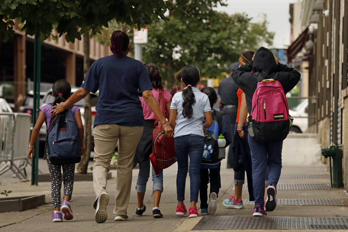 A group of children are taken to the Cayuga Center in East Harlem. Hundreds of migrant children separated from their parents by federal immigration officials are being cared for in the facility.