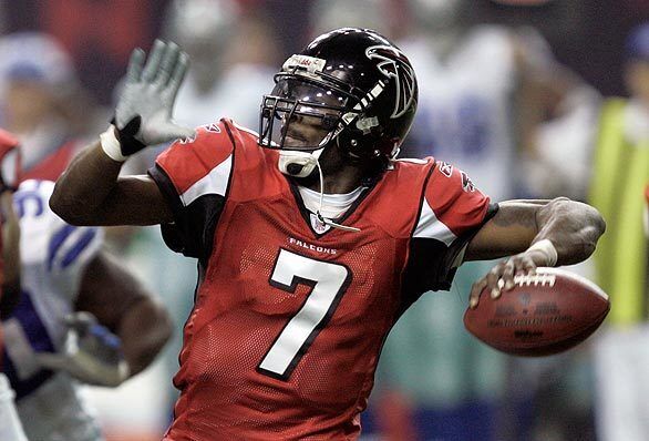 Playing for the Atlanta Falcons, quarterback Michael Vick gets ready to pass in a game against the Dallas Cowboys. In 2007, the NFL star would become embroiled in a case involving illegal dogfighting. He served 19 months in prison.