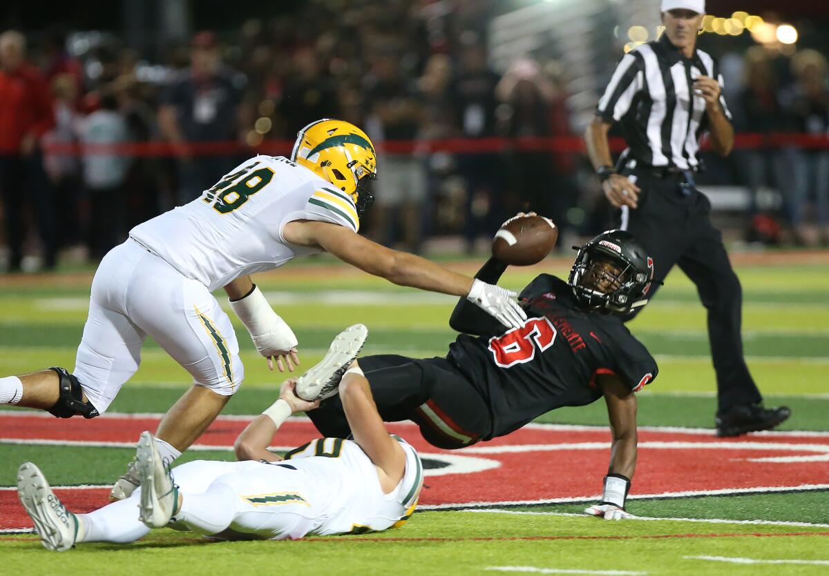 Edison's Trent Fletcher (20) and Kaleb Joyce (48) sack quarterback Nick Billoups in a nonleague game on the road Friday.