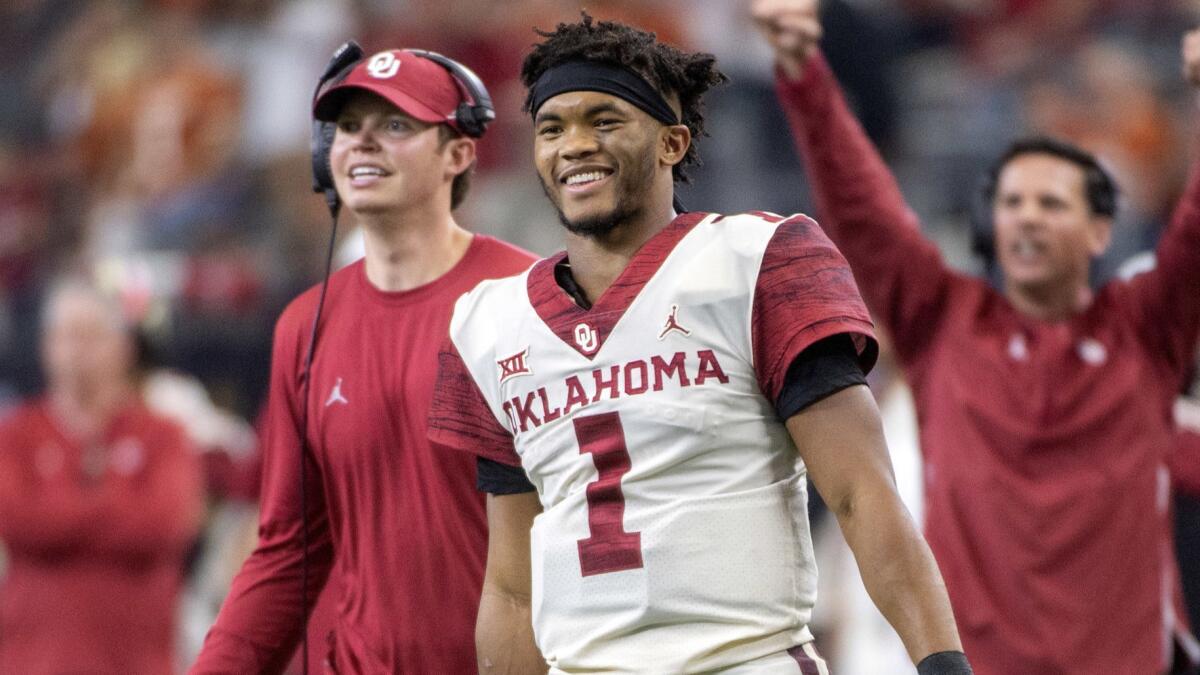 Oklahoma quarterback Kyler Murray celebrates on the sideline after throwing a touchdown pass on Dec. 1, 2018.