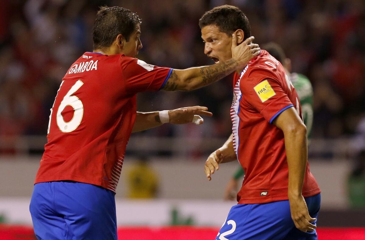 Costa Rica's Cristian Gamboa, left, celebrates with teammate Daniel Colindres, after Marcos Urena scored against Mexico during a 2018 Russia World Cup qualifying soccer match at the National Stadium in San Jose, Costa Rica, Tuesday, Sept. 5 2017.