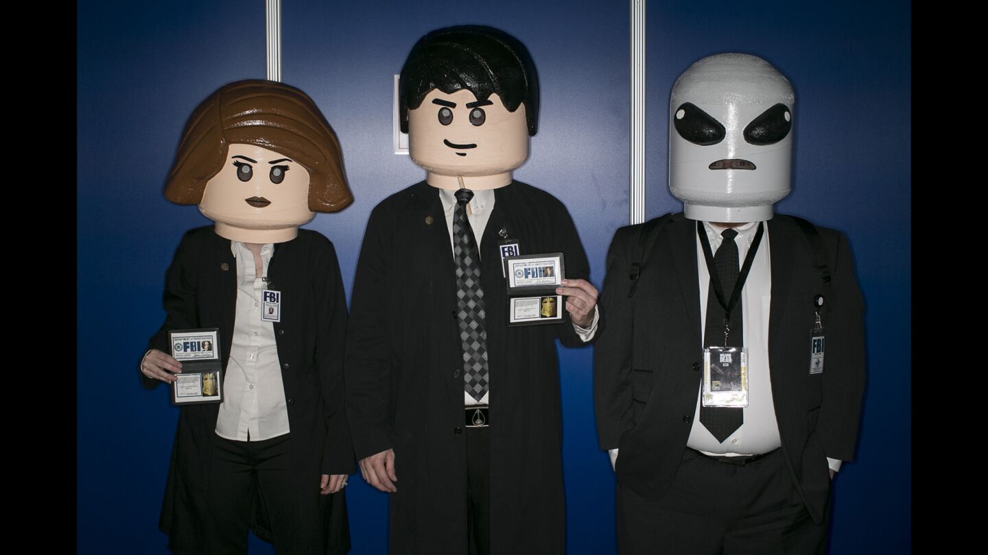 Lego X-Files characters from left are Haley Tracy as agent Dana Scully, David Tracy as agent Fox Mulder and Eric Downing as an alien at Comic-Con International 2016.