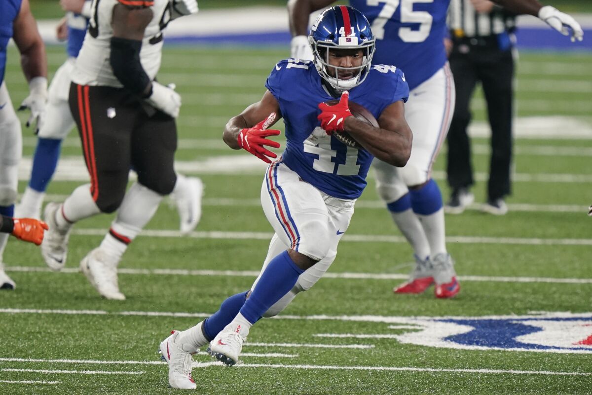 FILE - New York Giants' Alfred Morris (41) rushes during the first half of an NFL football game against the Cleveland Browns in East Rutherford, N.J., in this Sunday, Dec. 20, 2020, file photo. The Giants on Monday, Aug. 2, 2021, announced the re-signing of Alfred Morris. (AP Photo/Corey Sipkin, File)