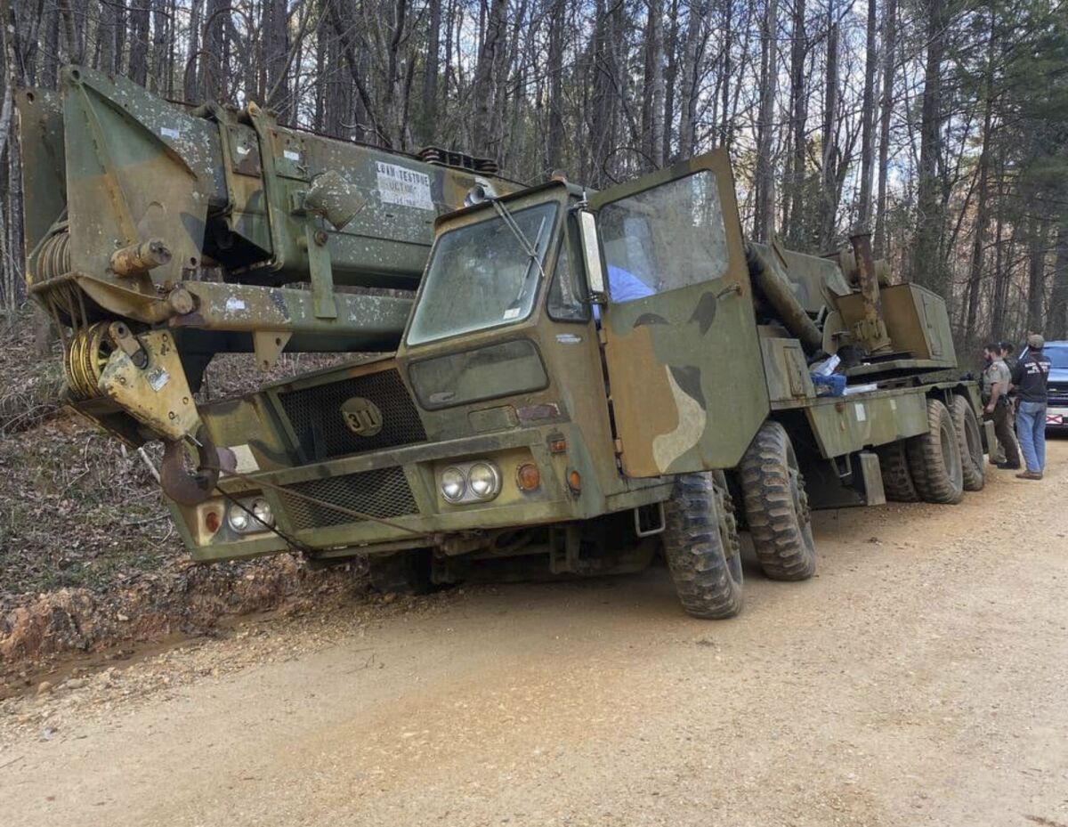 This photo provided by the Chilton County Sheriff's Office in Clanton, Ala., shows a 70-ton crane that was allegedly stolen on Monday, March 14, 2022. A man was arrested after calling a towing service asking to have it removed from woods, authorities said. (Chilton County Sheriff's Office via AP)
