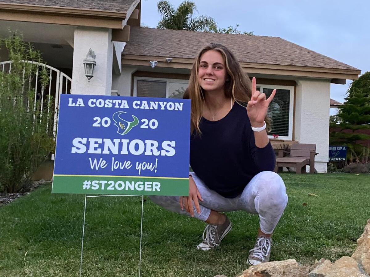 La Costa Canyon senior Sophie Tulino with a graduation sign that her mother, Anna Tulino, and other parents posted to celebrate the class of 2020.