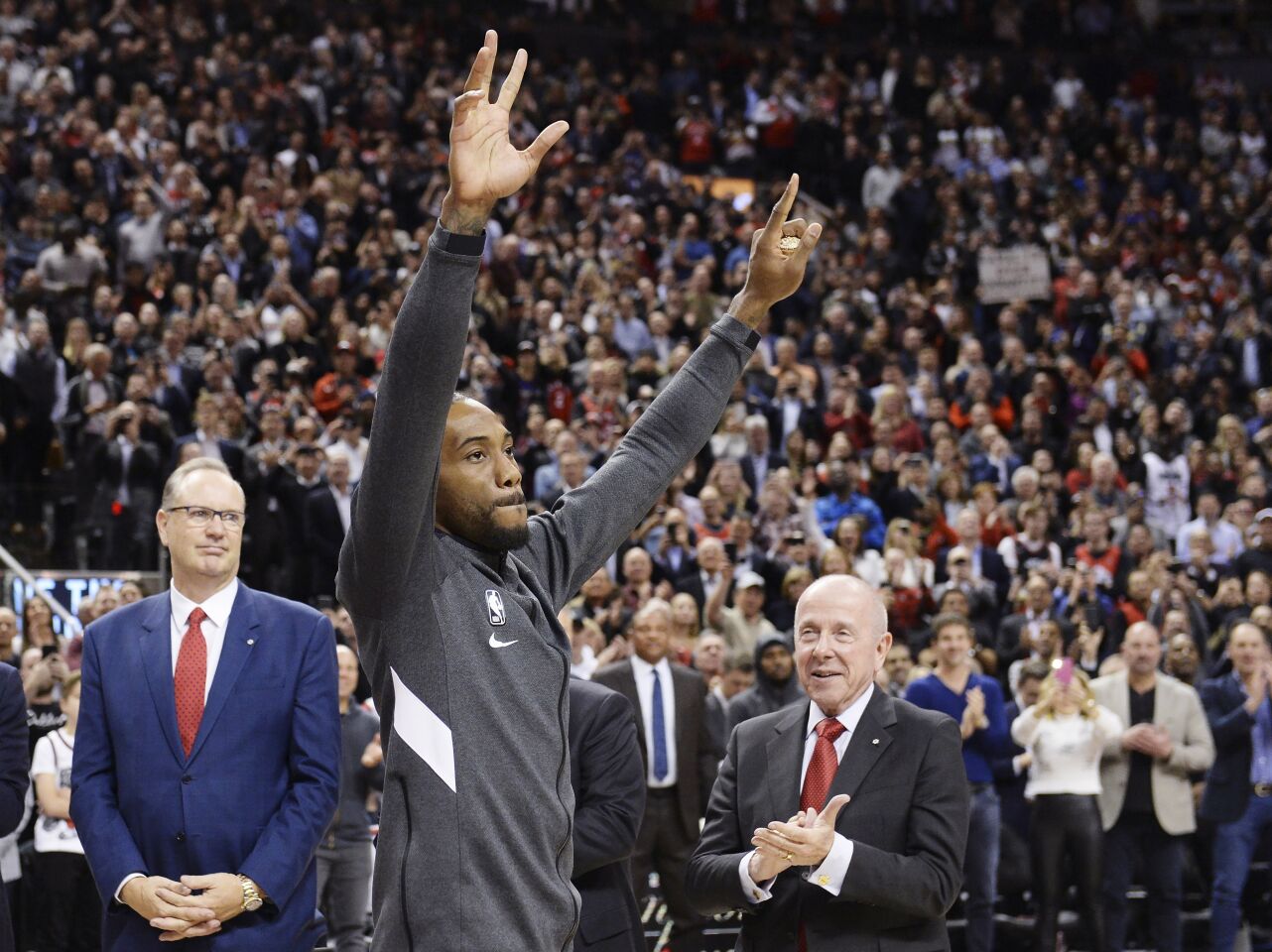 Kawhi Leonard salutes the crowd after receiving his 2019 NBA championship ring before a game between the Clippers and the Raptors.