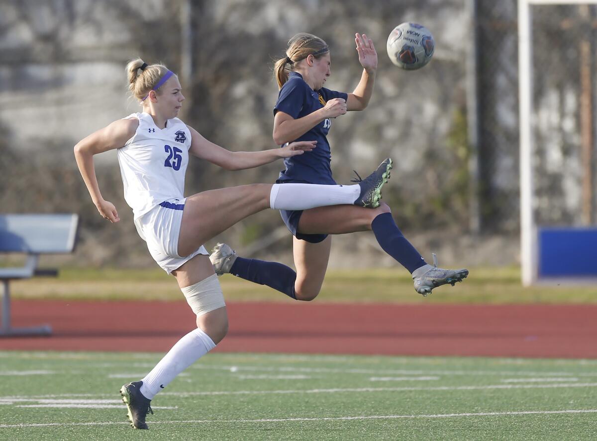 Marina's Samantha Esparza (20) and Webb's Kaitlyn Metz (25) battle to control a deep pass on Friday.