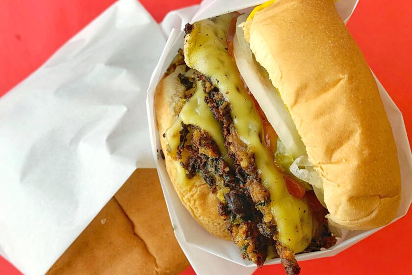 A veggie burger against a red background.