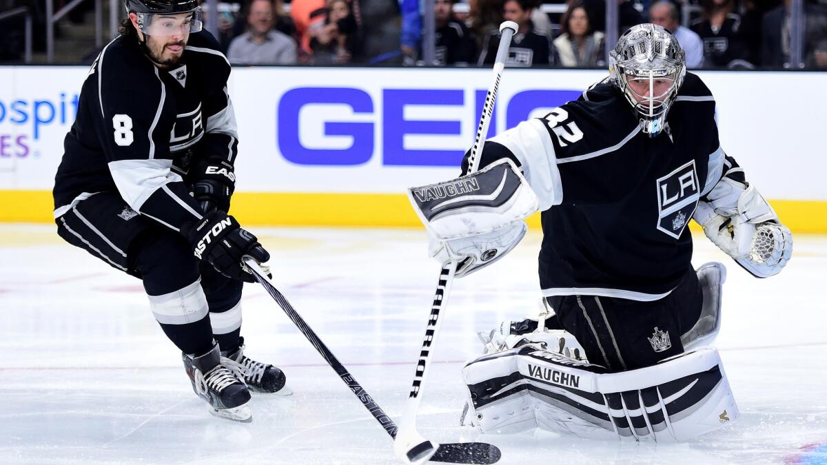 Kings defenseman Drew Doughty and goaltender Jonathan Quick clear a rebound against the Predators on Oct. 31.
