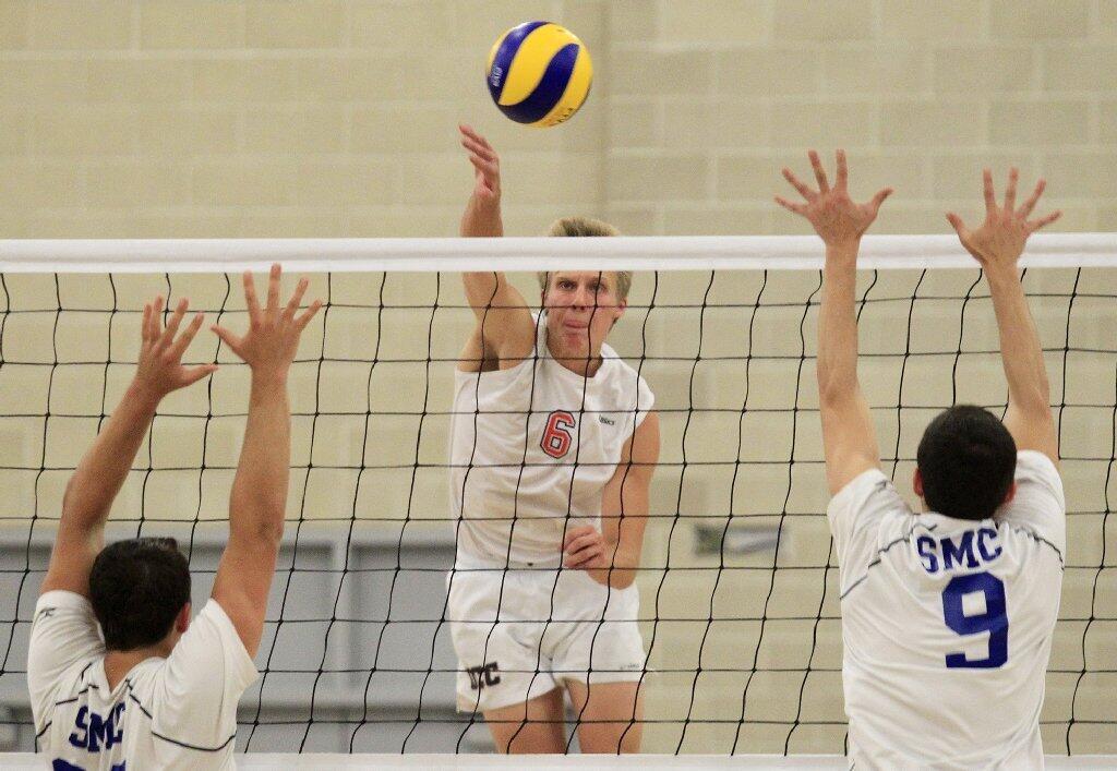 Orange Coast College's Ty Hutchins spikes the ball against Santa Monica in the 2014 California Community College Athletic Assn. State Championship match at Santiago Canyon College in Orange on Friday.