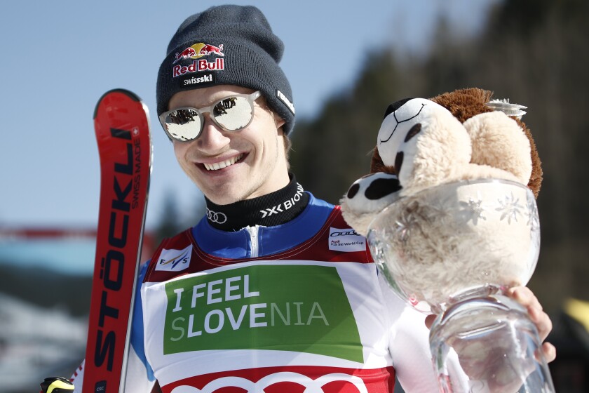 Second placed Switzerland's Marco Odermatt celebrates after an alpine ski, men's World Cup giant slalom race, in Kranjska Gora, Slovenia, Saturday, March 12, 2022. (AP Photo/Gabriele Facciotti)