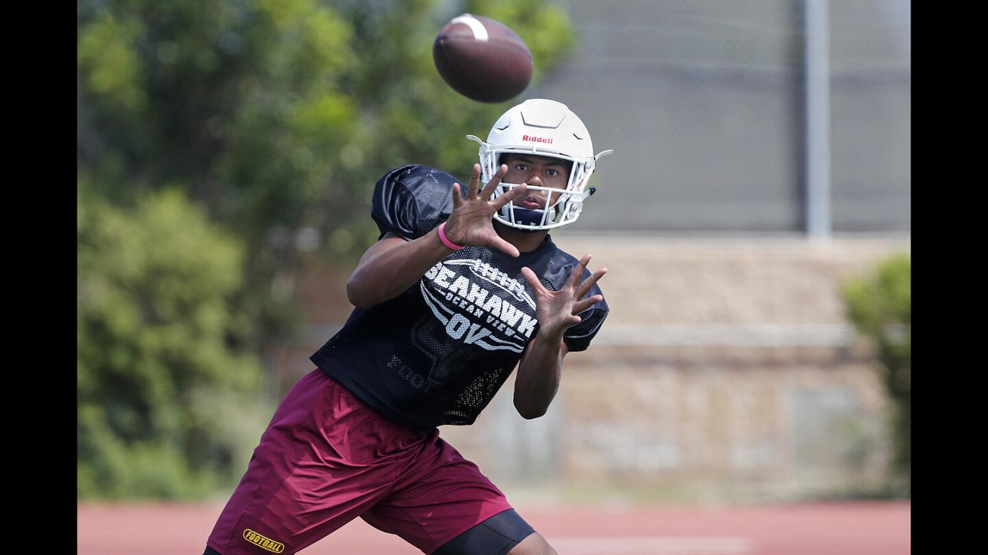 Ocean View High wide receiver Naeco Logan makes a catch during practice on Wednesday in Huntington Beach.
