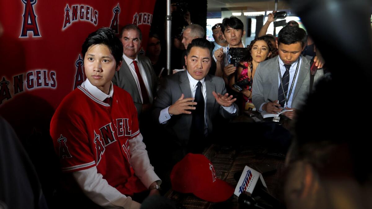Shohei Ohtani answers questions during his introductory press conference.