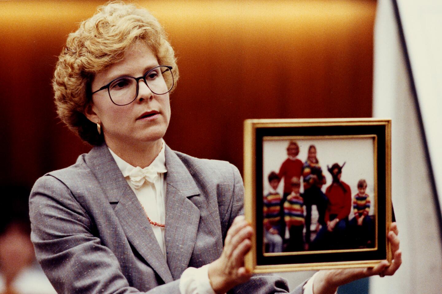 Prosecutor Kerry Wells holds a photograph during the trial on Oct. 15, 1991.