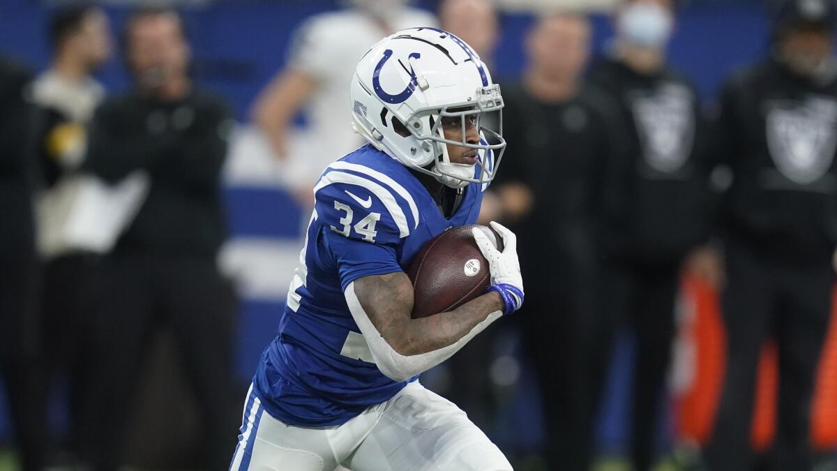 Indianapolis Colts cornerback Isaiah Rodgers runs up field after intercepting a pass.