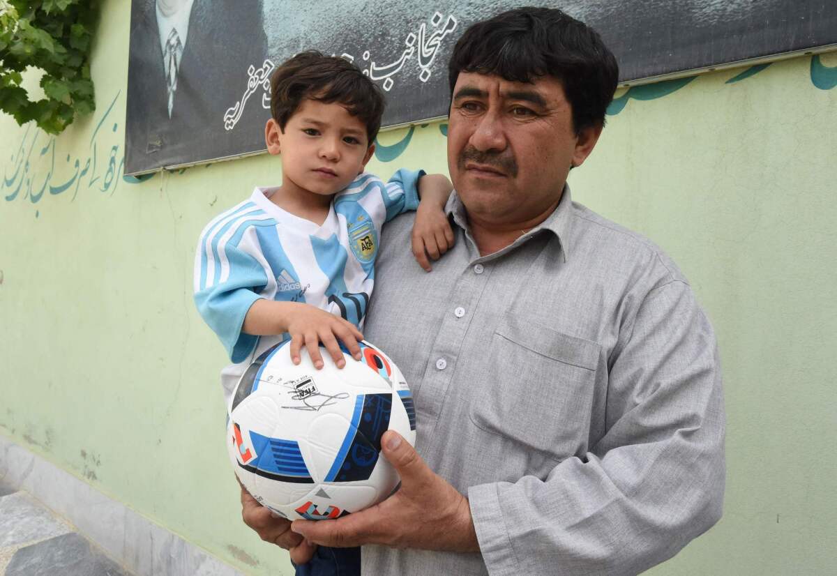Mohammad Arif Ahmadi holds his son, Murtaza, 5, near their home in Quetta, Pakistan on May 3.