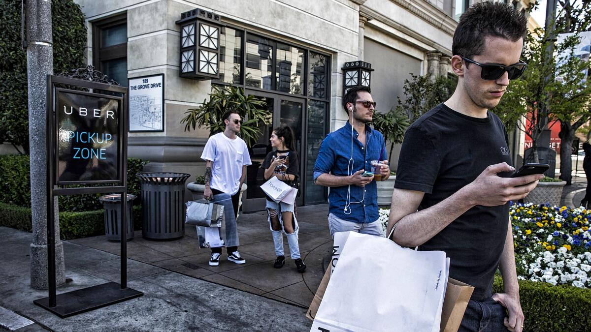 Shoppers at the Grove wait for Uber and Lyft rides in a designated zone on the east side of the property.