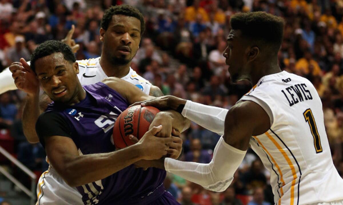 Stephen F. Austin's Desmond Haymon, left, tries to prevent Virginia Commonwealth's JeQuan Lewis, right, and Jordan Burgess from stealing the ball during the Lumberjacks' upset win Friday. Haymon has flourished in his leadership role with the team.