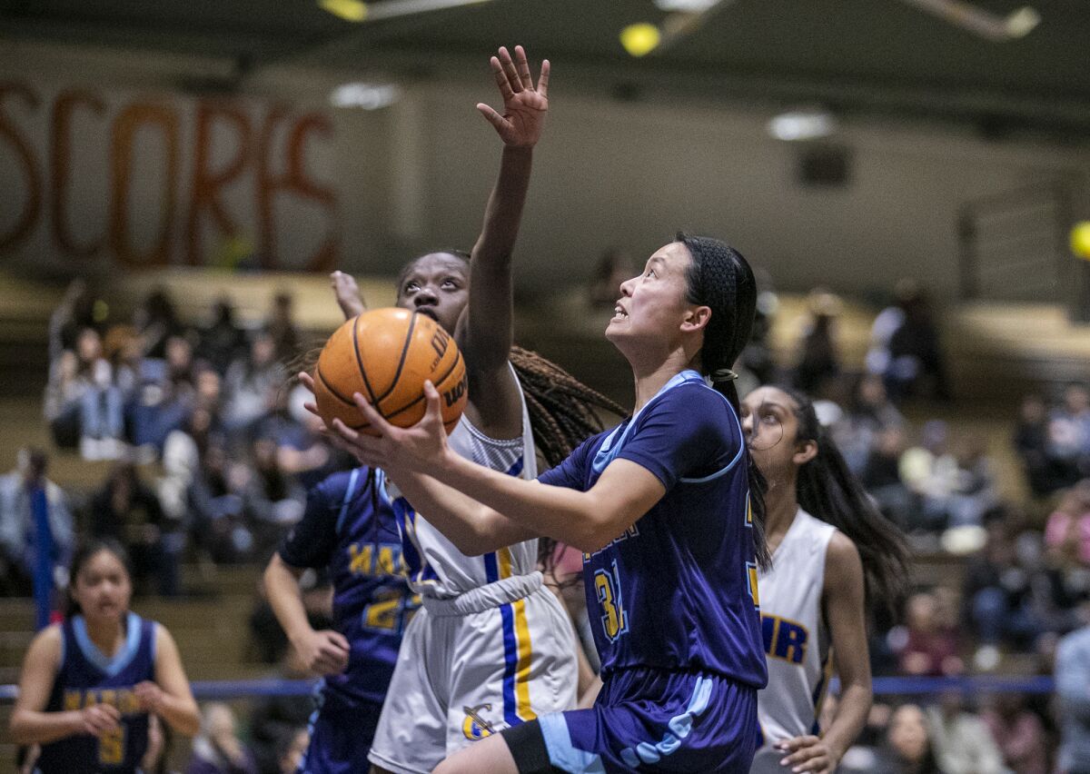 Marina's Tiana To goes up for a shot against a Gahr defender during Saturday night's game.